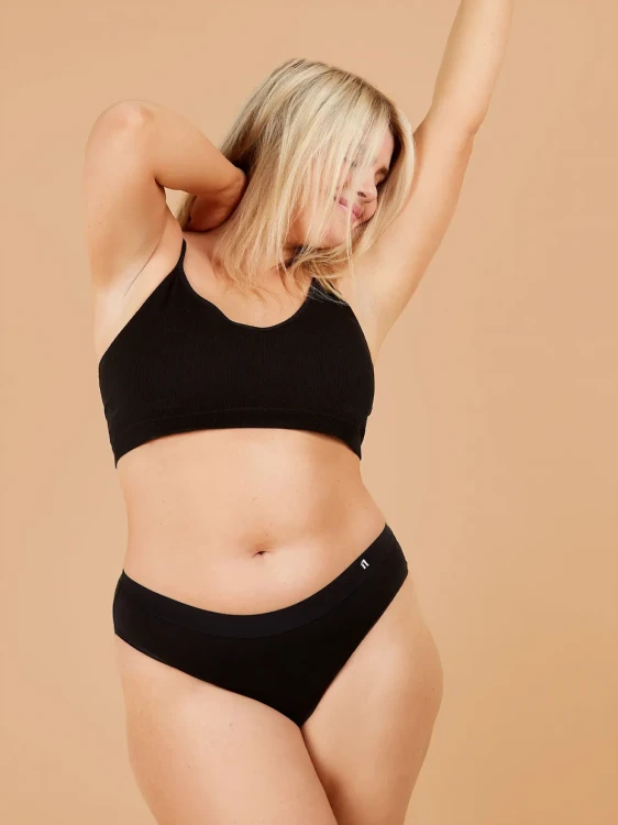 Czarne majtki menstruacyjne Fluxies Hipster na kobiecej sylwetce, widok z przodu